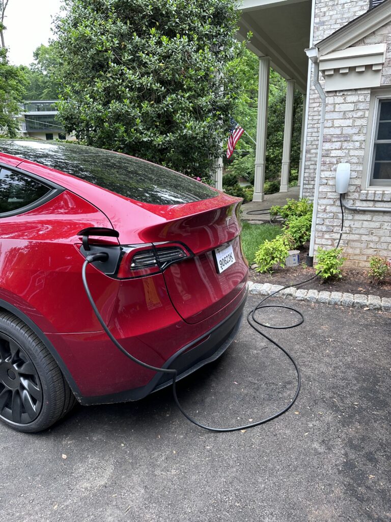 Tesla Wall Connector mounted on an exterior brick wall